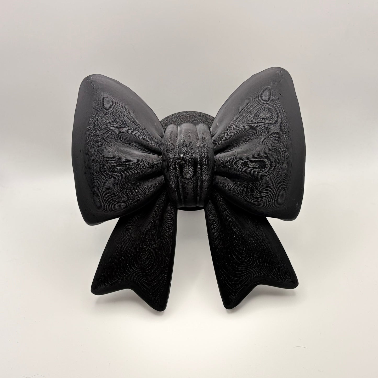 A large black bow tow hitch cover
